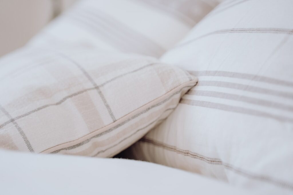 a close up of a pillow on a bed