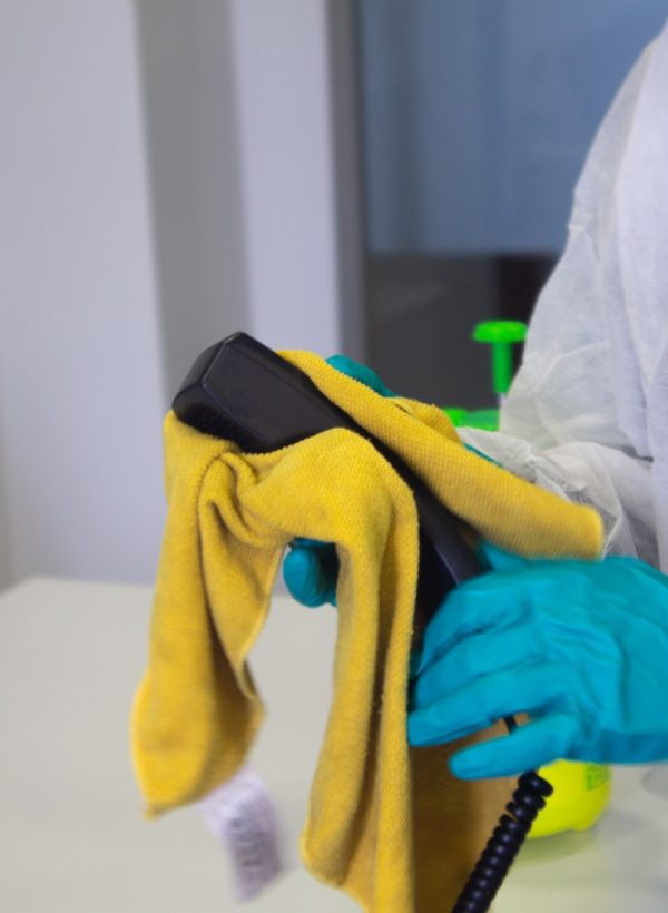 person in white robe holding black and yellow umbrella