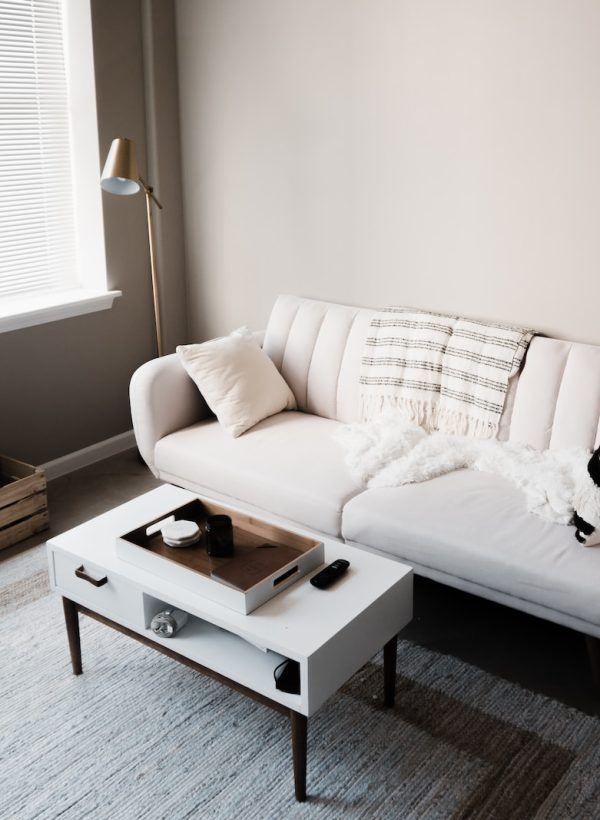 white couch in front of white wooden table