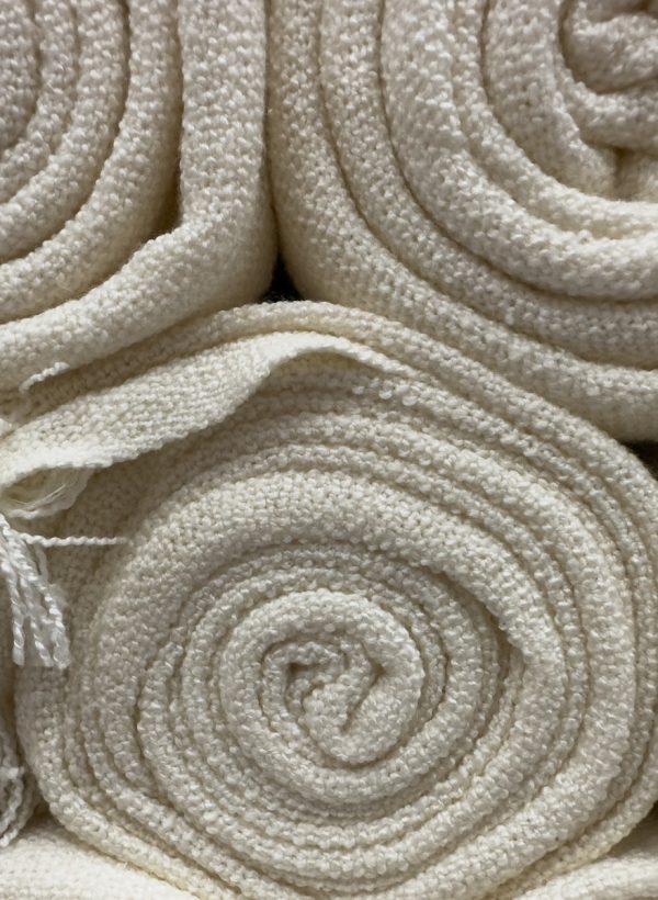 a bunch of white towels stacked on top of each other